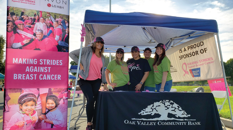 Several employees from Oak Valley Community Bank at their booth for a Breast Cancer Walk in Modesto