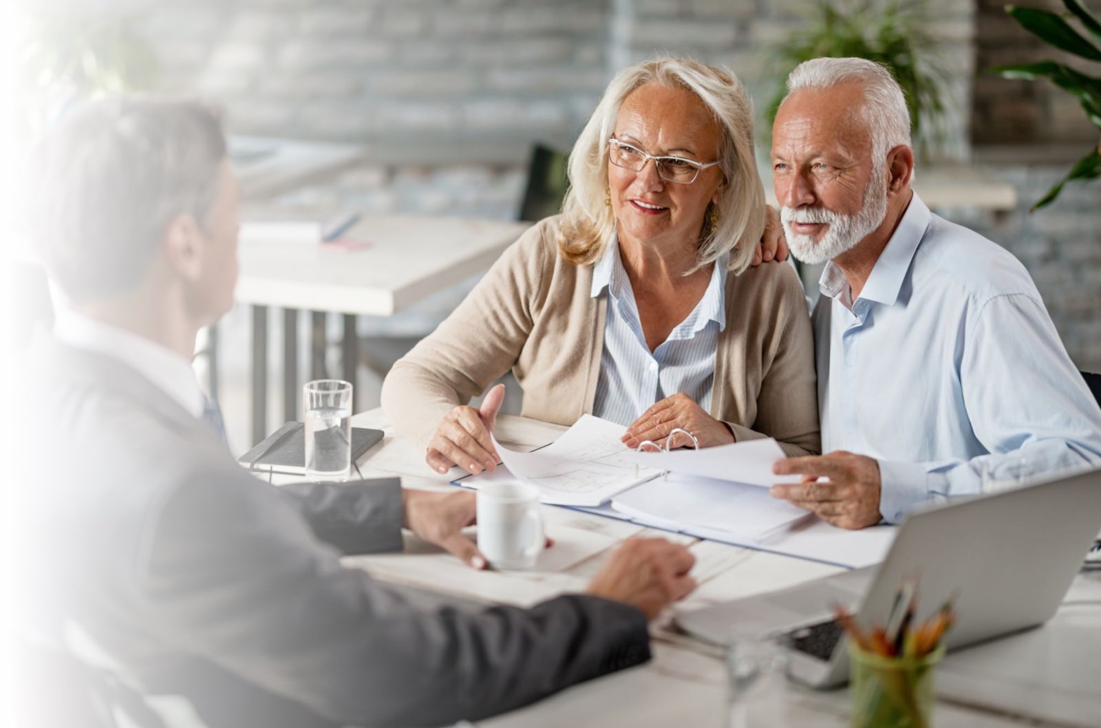 An older couple talking to an advisor about annuities