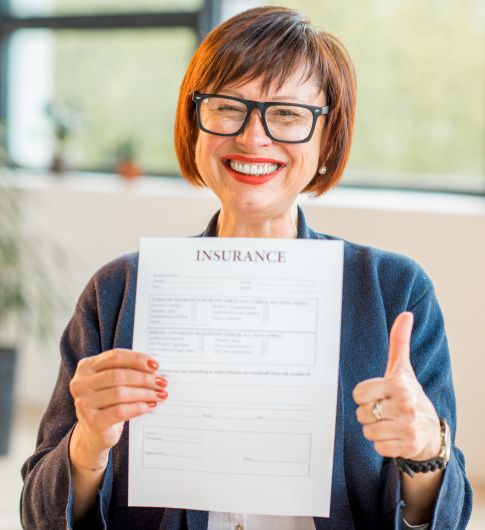 A woman holding up a life insurance application