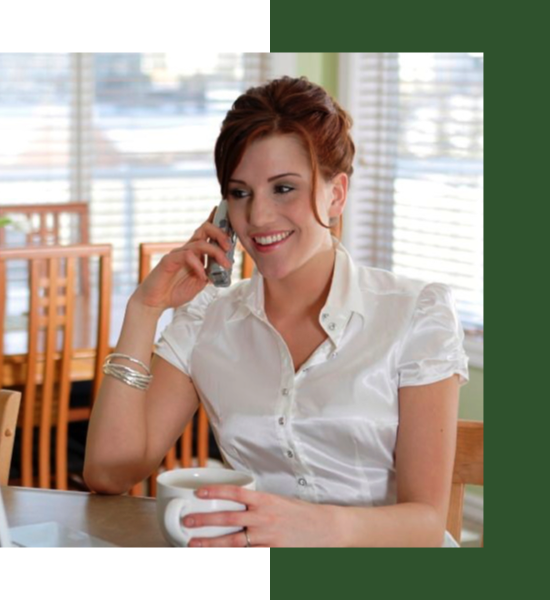 A woman sitting at a countertop while on the phone
